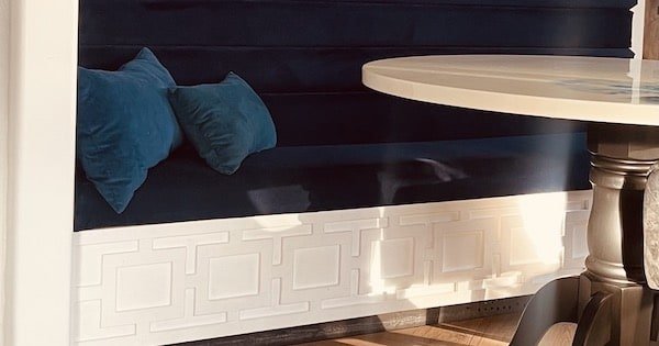 DIY navy blue upholstered Stoage Banquette with a fireplace
