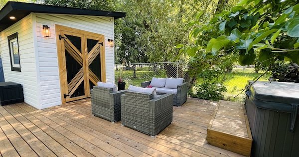 DIY Black and White diy shed exterior with deck and hot tub