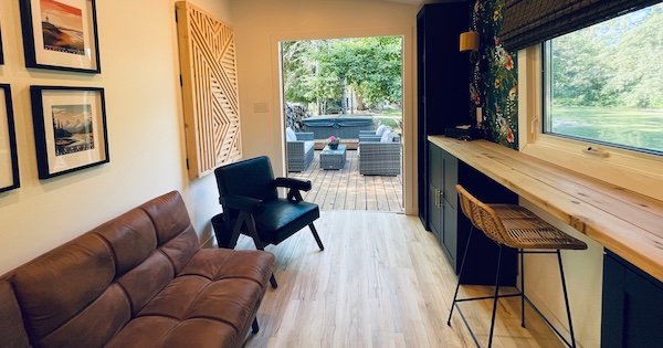 fully finshed shed with storage, built ins, seating and wallpaper