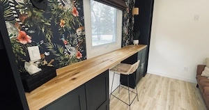 diy wall to wall black built in book cases and cabinets with a wood desktop