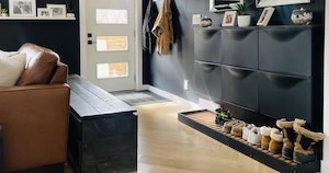 entryway in an open concept home with ikea trones, diy boot tray and wall hooks