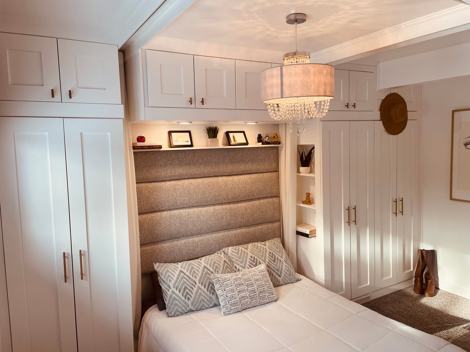 floor to ceiling wall to wall custom white wardrobes around the bed