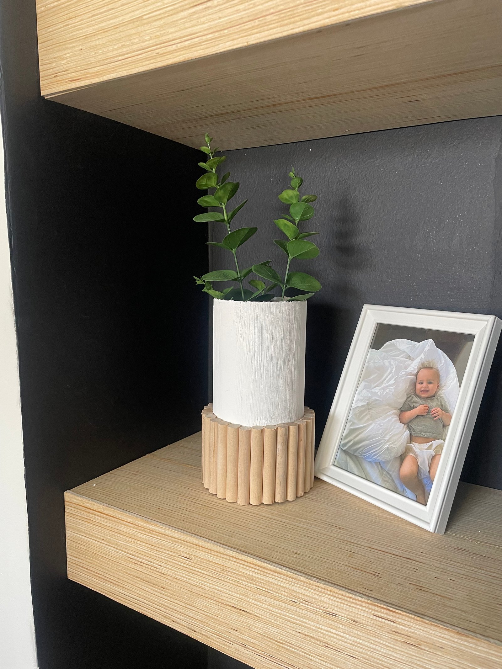 diy white painted vase with dowels on the lower half