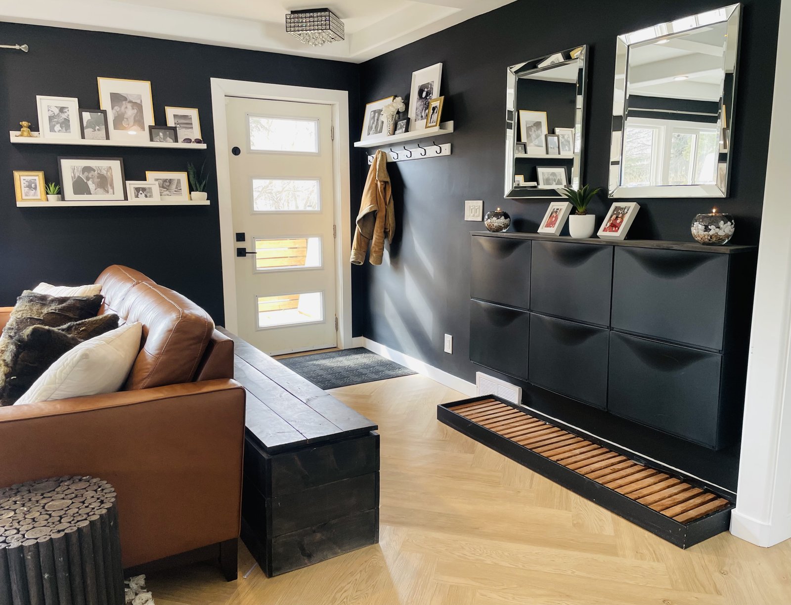 entryway in an open concept home with ikea trones, diy boot tray, mirros and picture ledge