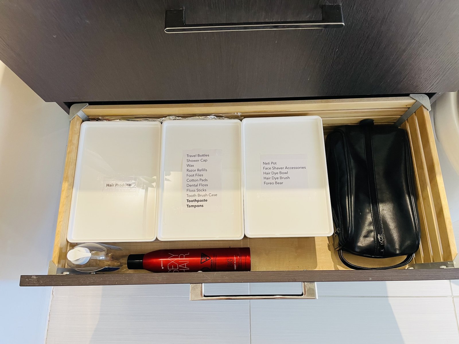 bathroom drawer reorganized into labeled bins from Ikea