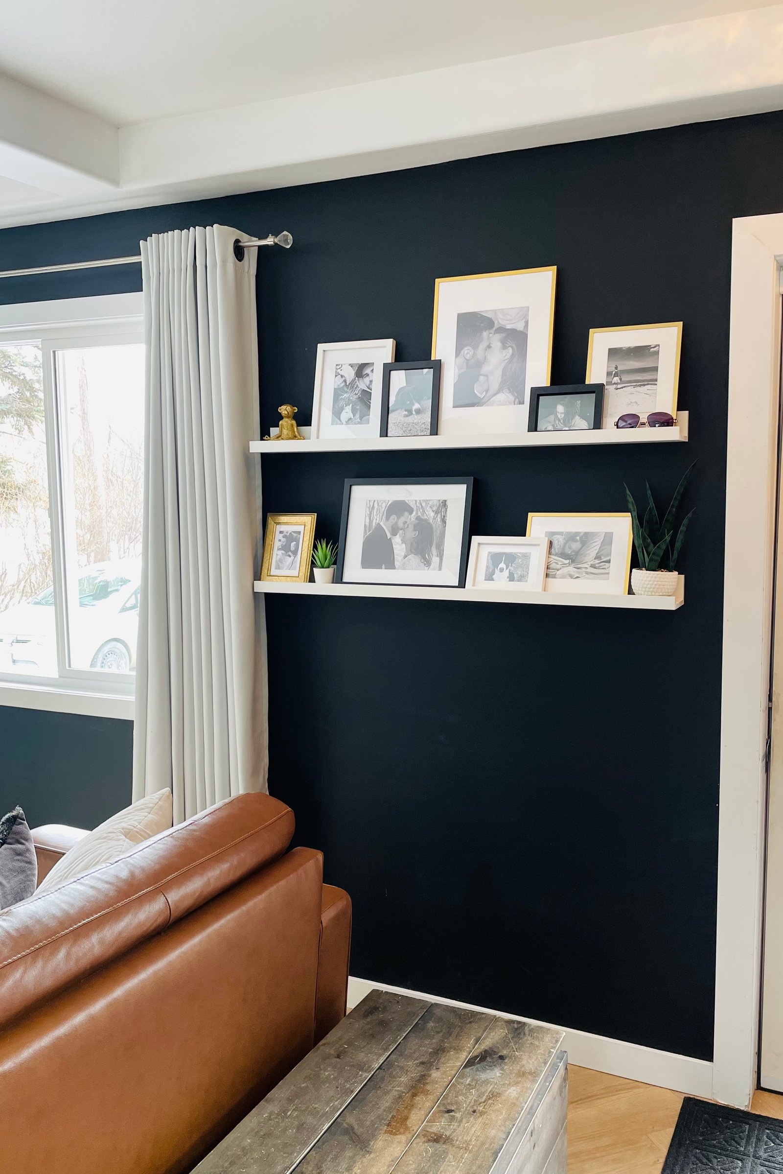 white ikea picture ledges styled with black and white family photos