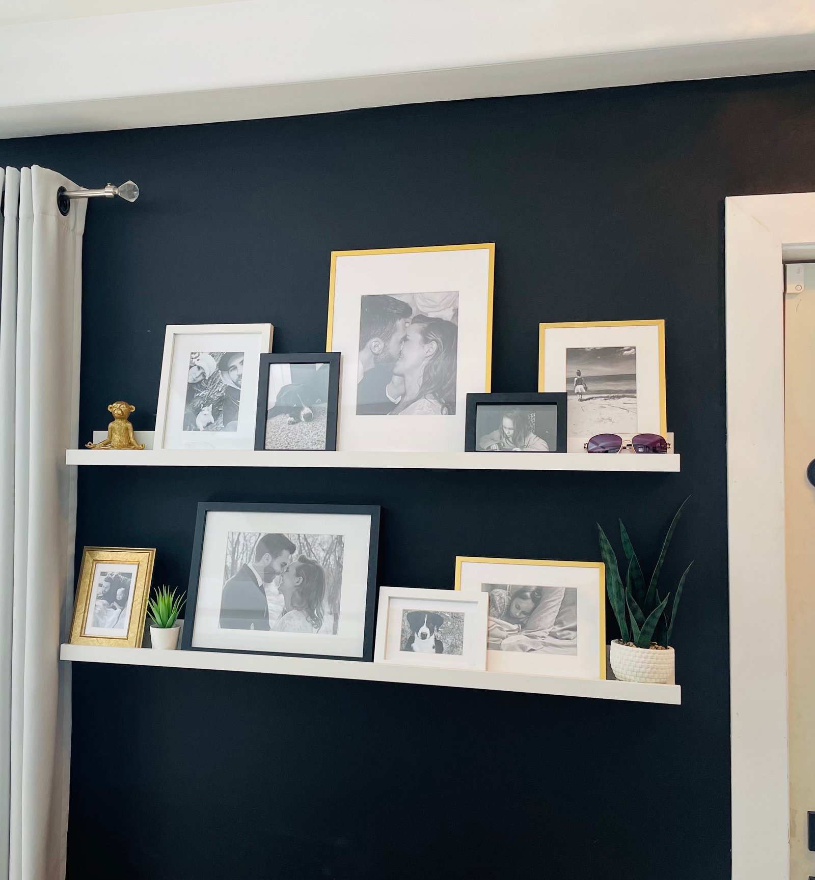 how to style a picture ledge on a budget with black and white family photos in black, white and gold ikea frames